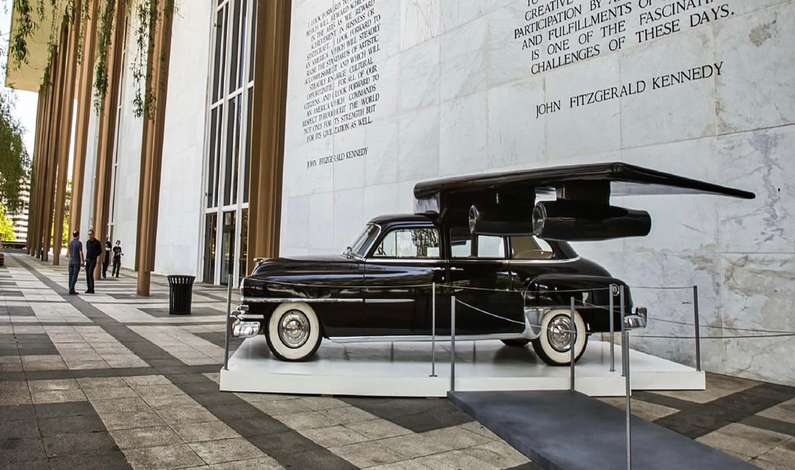 The sculpture roped off on a plinth in front of the Kennedy Center's marble colonnade, engraved with a John F. Kennedy quote.
