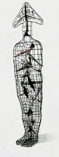 A slender wire-mesh human figure topped with a small triangular airplane shape in place of a head, dark tangled objects and a red marking visible inside the torso through the mesh.